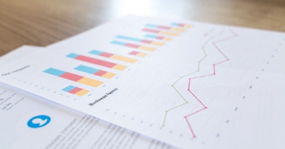 paper print outs with line graphs and business information