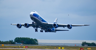 a blue and white aeroplane taking off