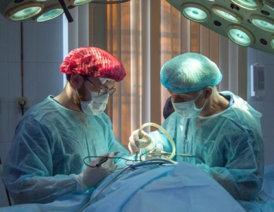 Two male surgeons performing surgery