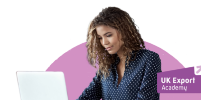 Woman using a laptop. UK Export Academy logo